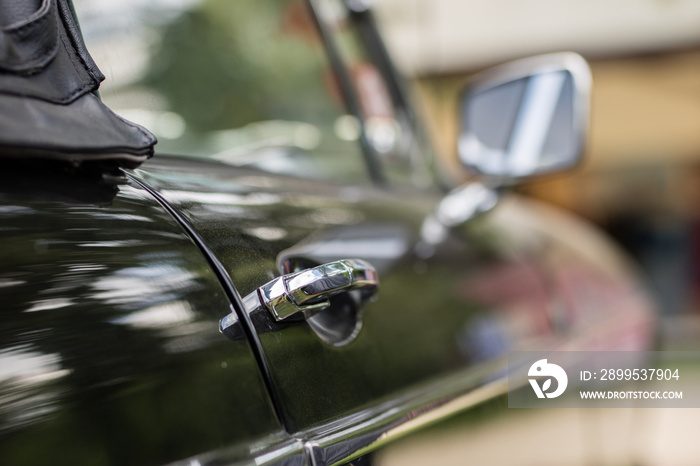 Chrome mirror in an old car. Accessories in cars exhibited at shows.