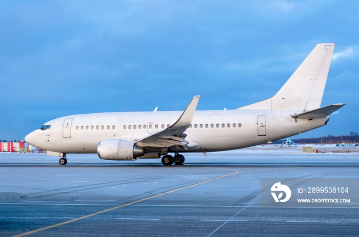 Passenger airplane on taxi in winter on slippery icy asphalt