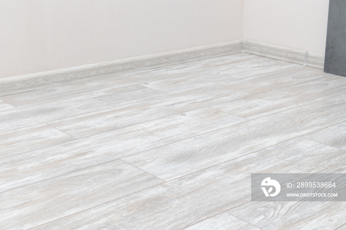 Empty room with laminate floor and wall.