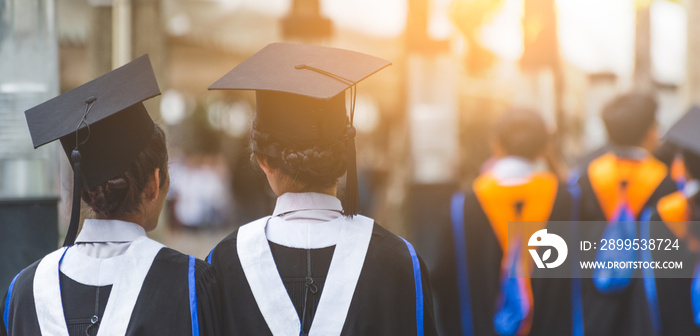 Education theme concept. Back view of Graduates during commencement.