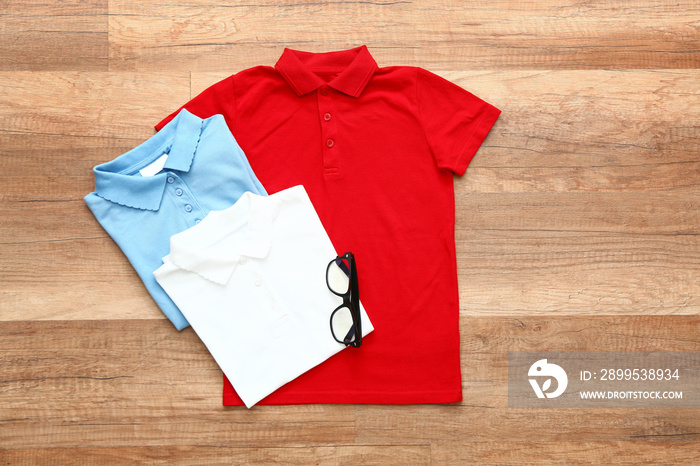 Stylish school uniform on wooden background