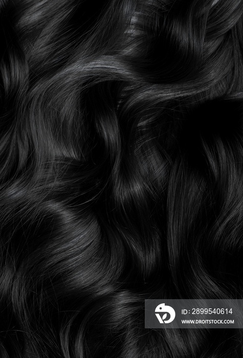 Brunette or black hair. Female long dark hair in black. Beautifully laid curls. Closeup texture in a dark key. Hairdressing, hair care and coloring. Shading gray hair. Background with copy space.