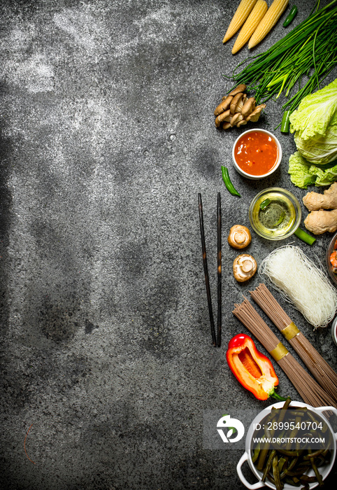 Asian food. A variety of ingredients for cooking Chinese or Thai food on a rustic background .