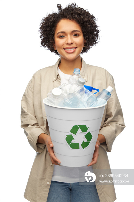 recycling, waste sorting and sustainability concept - smiling woman holding recycle bin with plastic bottles over white background