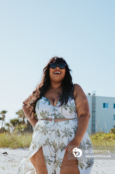 plus size African American woman standing at the beach smiling