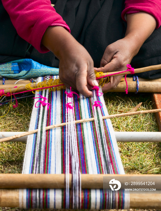 hands that sew typical costumes in Amantani on the Titicaca lake