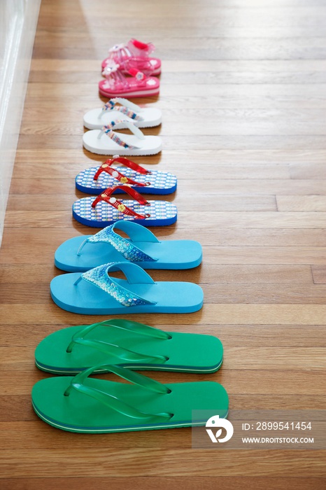 Row of flip-flops on floor elevated view