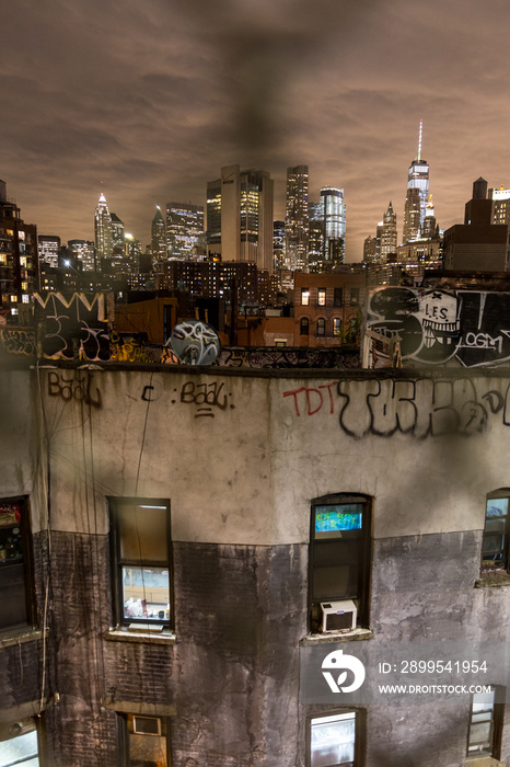 Manhattan bridge view over Chinatown at night, lower Manhattan in the background. New York City, United States of America.