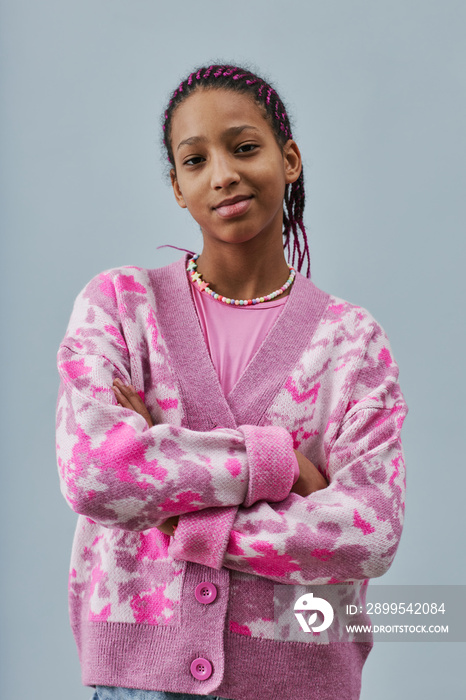 Black teenage girl posing confidently with arms crossed