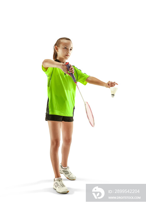 The one caucasian young teenager girl playing badminton at studio. The female teen player isolated on white background in motion