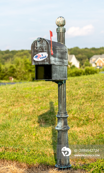 Metal mailbox for rural homes with I Voted sticker as concept for voting by mail or absentee ballot paper