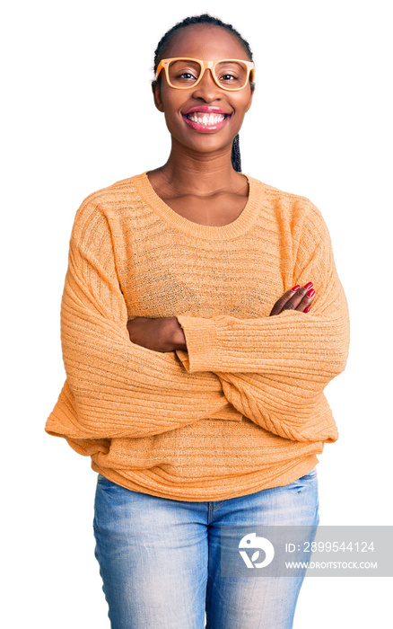 Young african american woman wearing casual clothes and glasses happy face smiling with crossed arms looking at the camera. positive person.