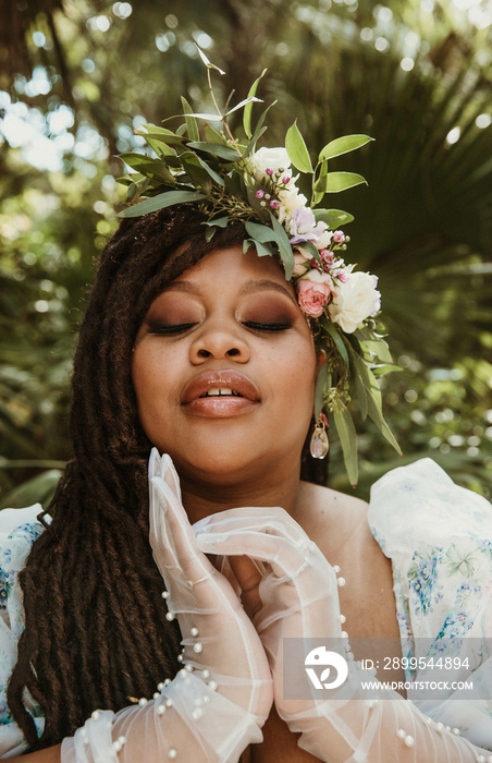 closeup portrait of a plus size Black woman with hands near face