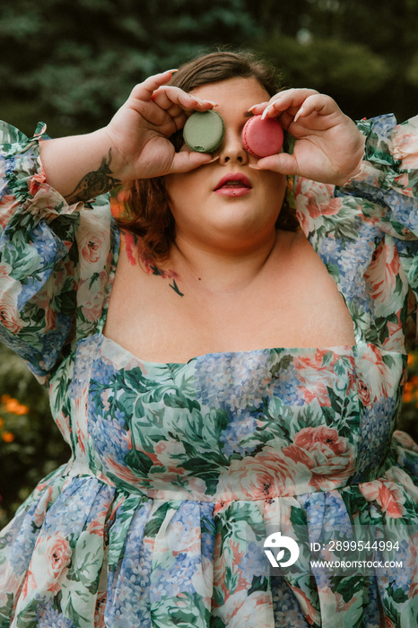 closeup of plus size woman with macarons on her eyes