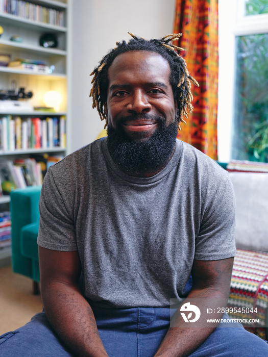 Portrait of man sitting on sofa