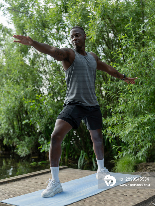 Man practicing yoga in park