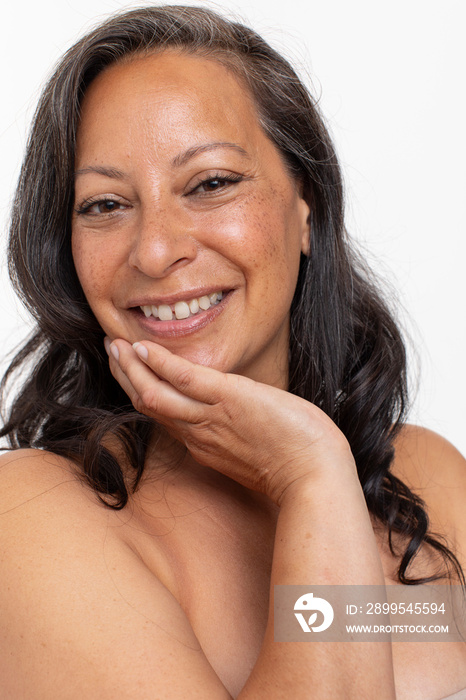 Studio portrait of smiling shirtless woman