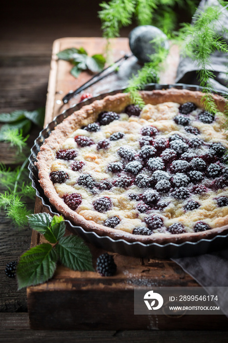 Homemade and sweet tart with blackberries with caster cugar