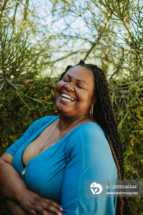 close up portrait of a plus size woman laughing eyes closed