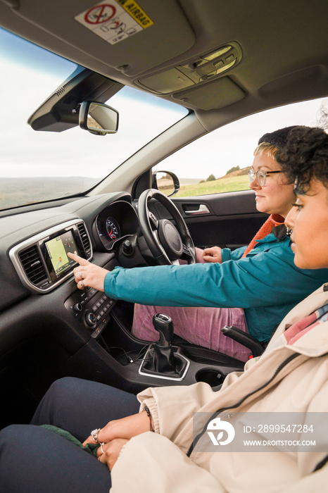 Female friends using GPS in car