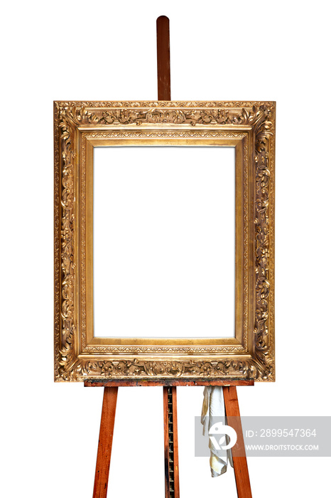 Painter’s easel and empty antique golden frame