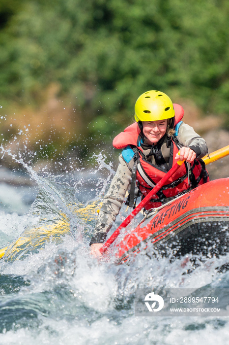 Water sport portrait of happy girl in river raft. Extreme sports and happiness concept.