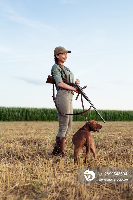 Beautiful female hunter with furry companion.