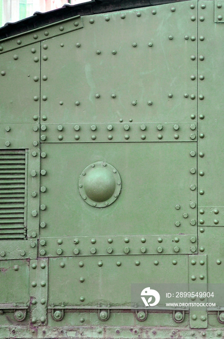 Texture of tank side wall, made of metal and reinforced with a multitude of bolts and rivets