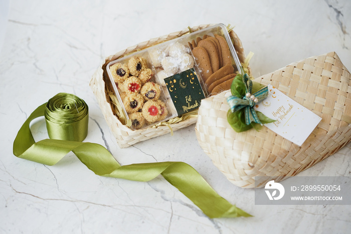 Ramadhan Hampers moslem theme for celebrate the holy, bake snack, nastar, bakery, cookies, pudding, choco chips, roll cake, castangel.with greeting card and green accessories on white background