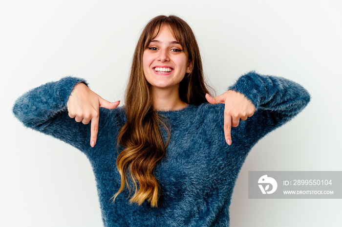 Young caucasian cute woman isolated on white background points down with fingers, positive feeling.