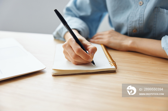 Closeup shot of woman’s hand writing to do list future plans for work week on the table in office. Modern Job Work Time management concept