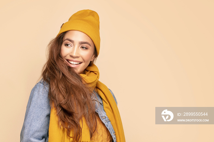 Happy girl in autumn cap and scarf.