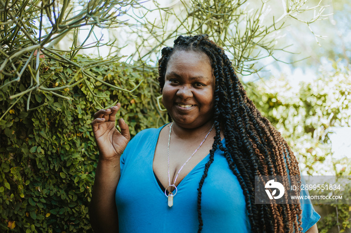 plus size Afro Latinx Haitian American touching plants