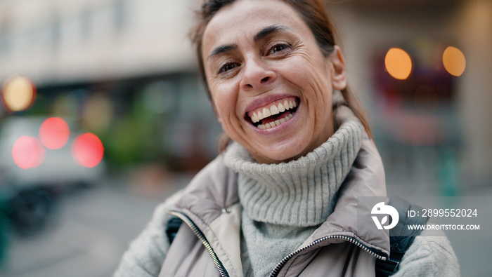 Middle age hispanic woman smiling confident standing at street