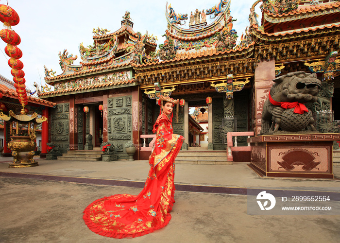 Portrait Asia woman with red Cheongsam Traditonal Chinese Dress at Chinese Shrine, Letter on Larnter means Good Wheather , Happy New year