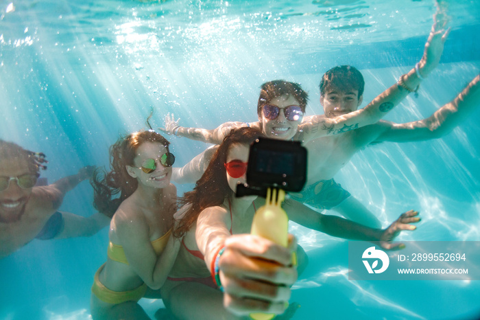 Group of young people taking selfie underwater