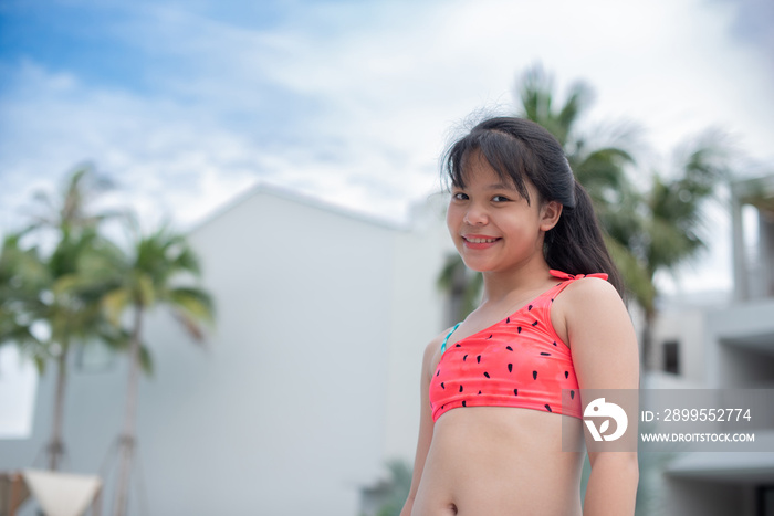 Happy girl enjoying summer vacations in a pool. Summer holidays, children’s swimming, Pool woman on holidays in tropical resort swimming. summer vacation concept.