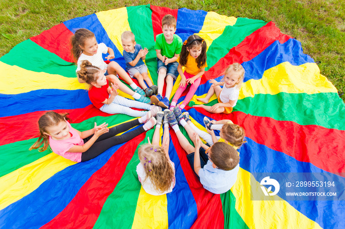 Kids holding hands together with teacher in gym