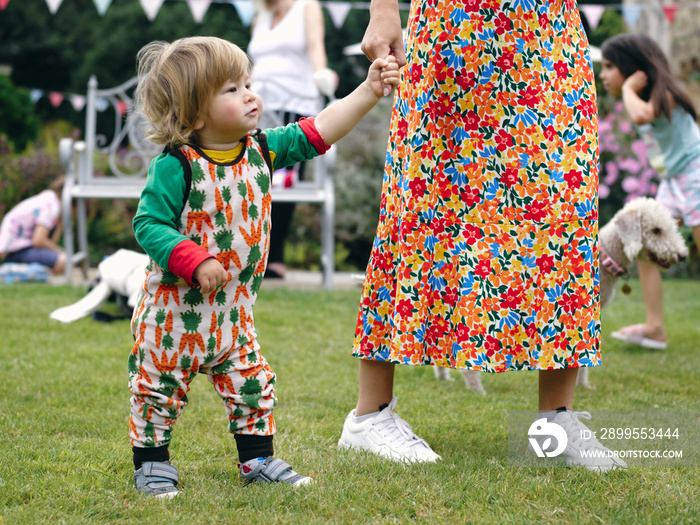 Mother walking with baby son