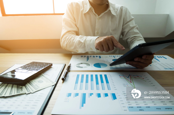 Businessman using tablet to the situation on the market value , Business concept.