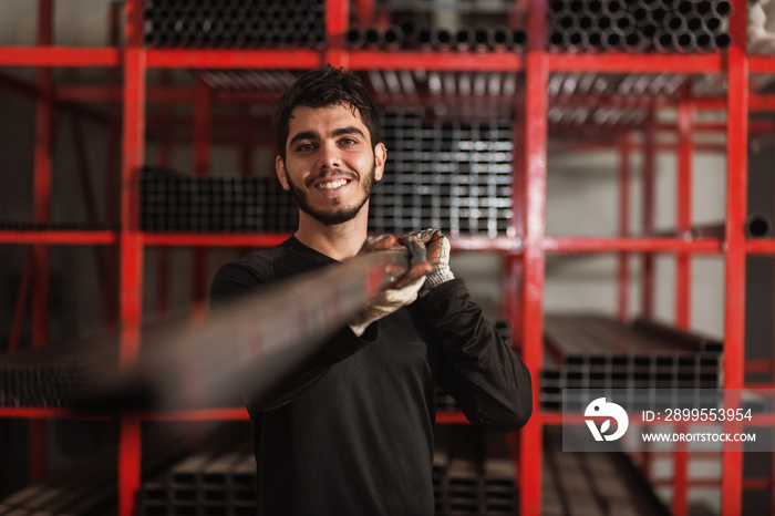 Small Latin entrepreneur in his shop of metal bars for construction.