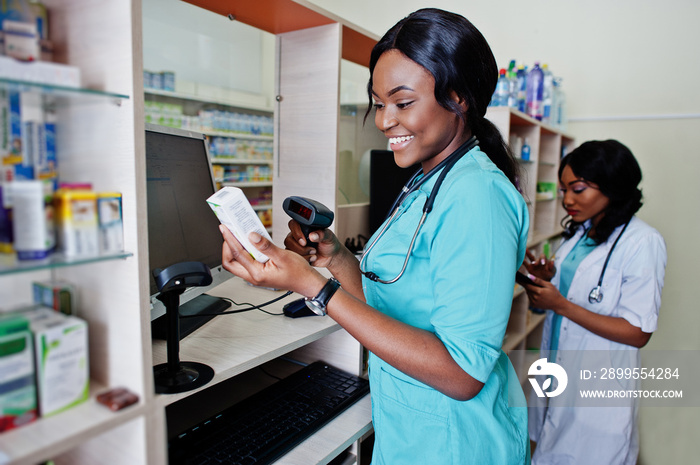 Two african american pharmacist working in drugstore at hospital pharmacy. African healthcare.