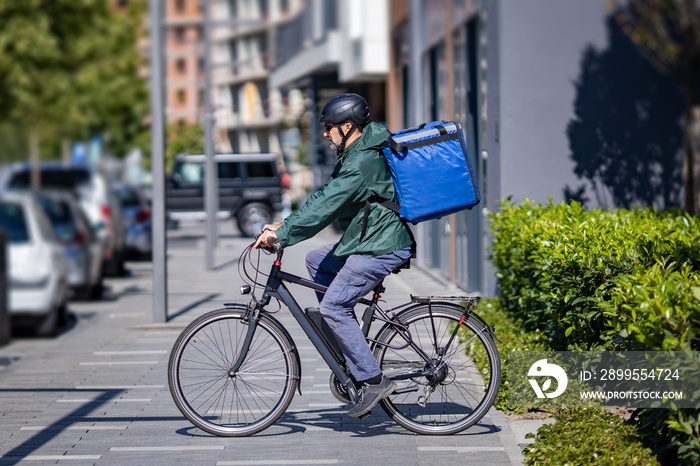 deliveryman riding electric bicycle in city