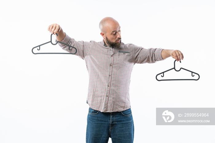 Man holds in his hand a hangers isolated on white