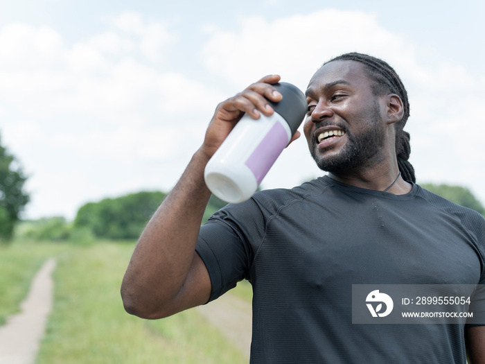 Man drinking from water bottle during workout