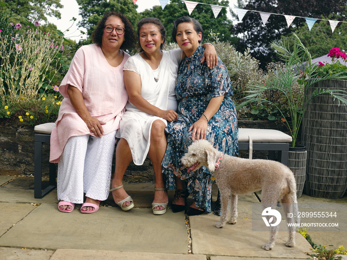 Portrait of mother with mature daughters and dog