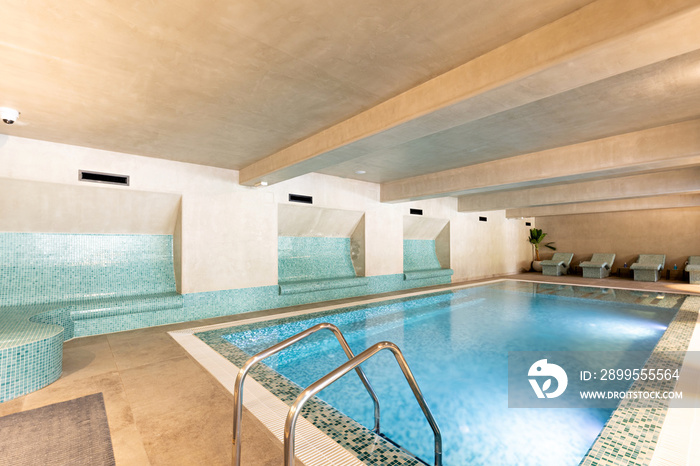 Indoor swimming pool in hotel wellness center