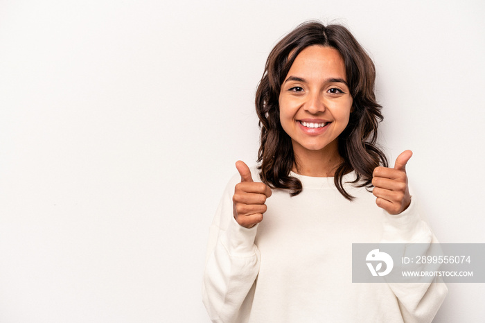 Young hispanic woman isolated on white background smiling and raising thumb up