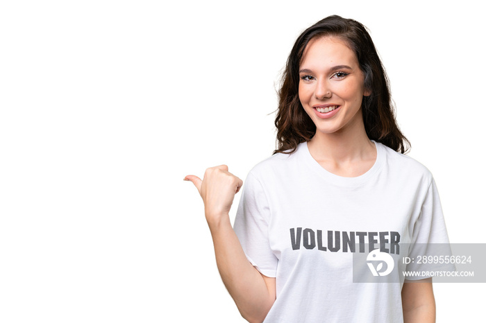 Young volunteer caucasian woman over isolated background pointing to the side to present a product