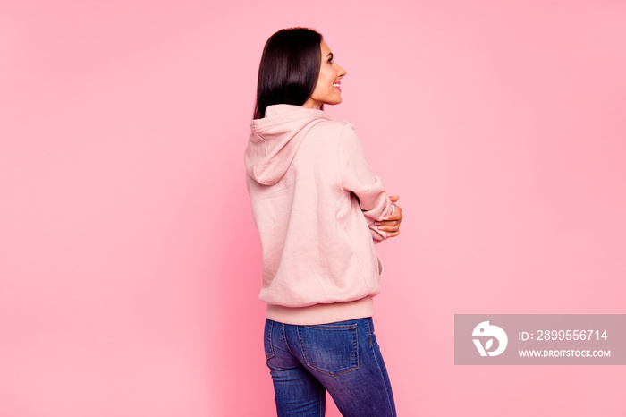 Rear back view of nice cute sweet lovely attractive charming pretty nice-looking cheerful cheery latin girl in sweater jeans isolated over pastel pink background